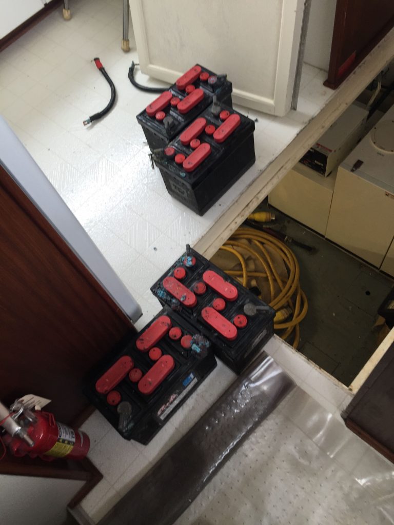 Replacing the bow thruster battery bank located below the galley floor.